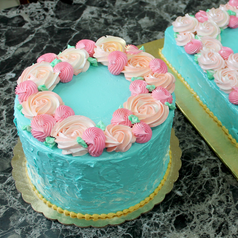 Peachy Pink Rosettes Over Blue Buttercream Cake